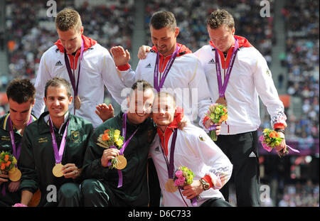 The German relay team Markus Rehm (l-r above), Heinrich Popow, David Behre and Wojtek Czyz are seen with their bronze medals and South Africans gold medalists Zivan Smit (l-r), Arnu Fourie and Oscar Pistorius during the victory ceremony for men's 4x100m relay -T42-46 at the Olympic Stadium during the London 2012 Paralympic Games, London, Great Britain, 06 September 2012. Photo: Jul Stock Photo