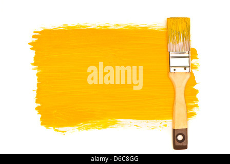 Yellow paint and brush on white studio Stock Photo