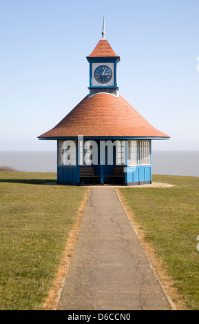 Seaside shelter and clock tower by the sea on the Greensward, Frinton on Sea, Essex, england Stock Photo