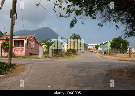Nevis Peak rises in the distance beyond residential houses on the Caribbean island of Nevis