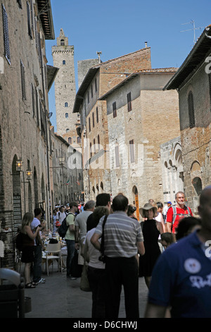 Tourists in the main street of San Gimignano, Tuscany Italy Stock Photo