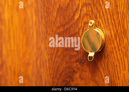 Peephole on wooden door Stock Photo