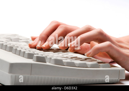 hands typing on keyboard Stock Photo