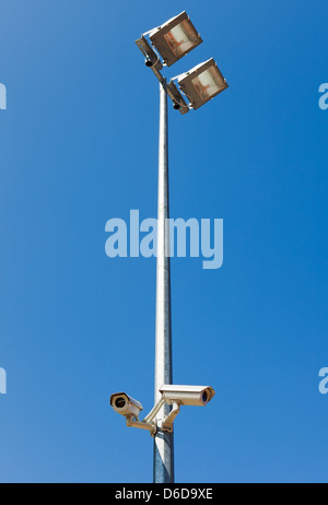 Surveillance camera on light pole in parking Stock Photo
