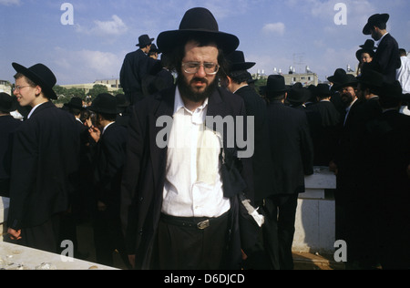 Ultra Orthodox Jew with ripped clothes as a gesture of mourning at a Rabbi funeral in the city of Bnei Brak or Bene Beraq a center of Haredi Judaism in Israel Stock Photo