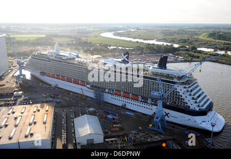 FILE - a file photo dated 08 September 2012 shows the new cruise ship 'Celebrity Reflection' moored at the fitting pier of the Meyer shipyard in Papenburg, Germany. The cruise ship is expected to be transferred from the Meyer shipyard via the Ems River to the North Sea on 15 September 2012. Photo: INGO WAGNER Stock Photo