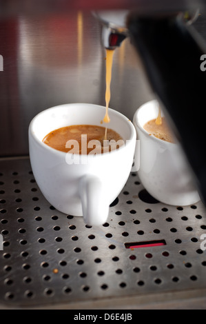 Italian espresso coffe making with professional machine macro  Stock Photo