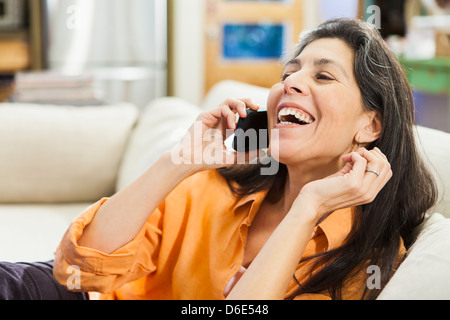 Older Hispanic woman talking on cell phone Stock Photo