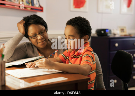 Mother helping son with homework Stock Photo