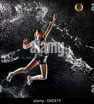 Caucasian volleyball player splashing in water Stock Photo