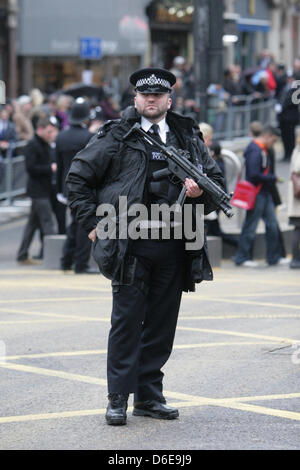 London, UK. 17 April 2013. Armed Police officer waits at Ludgate Circus for Baroness Thatcher's funeral cortège makes its way along Fleet Street en route to St. Paul's Cathedral Stock Photo