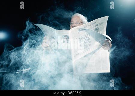 (HANDOUT) An undated handout shows former German Chancellor Helmut Schmidt sitting shrouded by a smoke cloud behind a copy of the Frankfurter Allgemeine Zeitung newspaper (FAZ) in Hamburg, Germany. For the current advertising campaign, the 93 year old former chancellor was photographed doing his too favorite things: smokeing and reading the newspaper. Photo: FAZ/Scholz & Friends/Jo Stock Photo