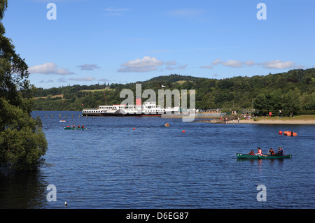 Loch Lomond on a summers day showing the Maid of the Loch Paddle Steamer and people canoeing and using the water Stock Photo