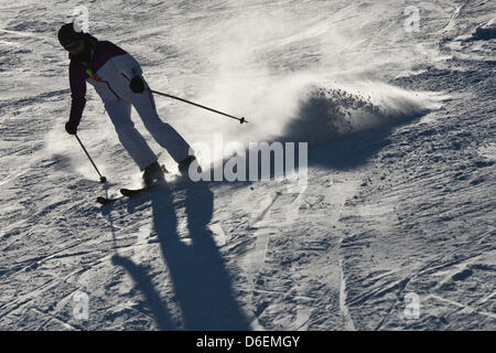A woman races down the downhill run at the winter sports arena  Holzelfingen in Lichtenstein, Germany, 05 February 2012. The sunny but frosty weather offered perfect conditions for skiing. Photo: Tobias Kleinschmidt Stock Photo