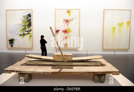 A visitor to the preview of the exhibition 'Turner - Monet - Twombley' stands in front of paintings by Cy Twombly at the State Gallery in Stuttgart, Germany, 08 February 2012. The sculpture 'Winter Passage Luxor' (1985) by Cy Twombly is displayed in the foreground. The exhibition is presenting the late works of artists William Turner, Claude Monet and Cy Twombly is open from 11 Feb Stock Photo