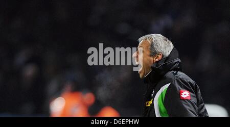 Gladbach's head coach Lucien Favre yells to the pitch during the DFB Cup quarter-final match between Hertha BSC and Borussia Moenchengladbach at the Olympic Stadium in Berlin, Germany, 08 February 2012. Photo: HANNIBAL (ATTENTION: The DFB prohibits the utilisation and publication of sequential pictures on the internet and other online media during the match (including half-time). A Stock Photo