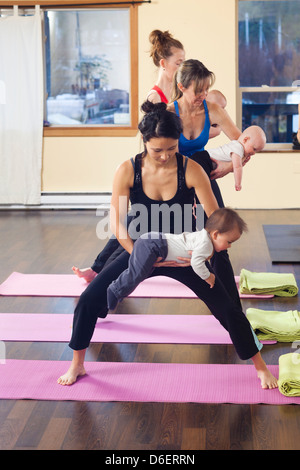 Mothers and babies taking yoga class Stock Photo