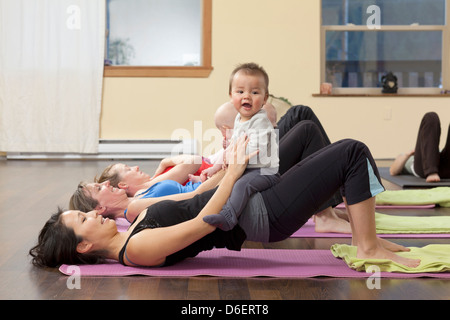 Mothers and babies taking yoga class Stock Photo