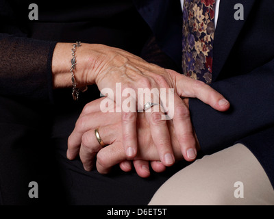 Close up of older couple's clasped hands Stock Photo