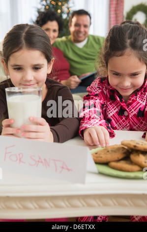 Girls leaving milk and cookies for Santa Stock Photo