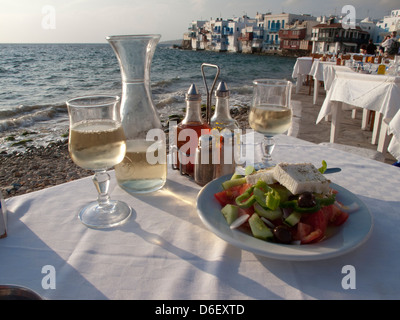 Greek salad and al fresco dining scene on the Greek island of Mykonos, Greece Stock Photo