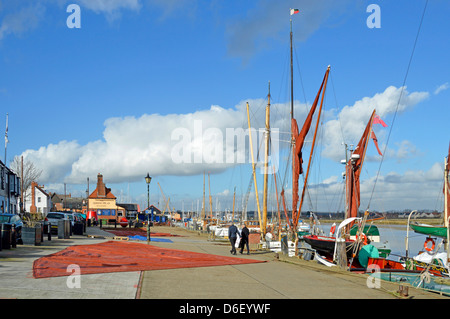 Winter walking beside River Blackwater at Hythe Quay sails from Thames barges laid out in blue sky sunshine & white cotton wool clouds Maldon Essex UK Stock Photo