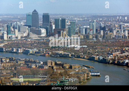 Aerial view London urban landscape & cityscape landmarks at Canary Wharf skyline bends in River Thames flood barrier piers distant England UK Stock Photo