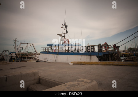 fishing boat moored in canal of Tiber river in Fiumicino Rome, Stock Photo