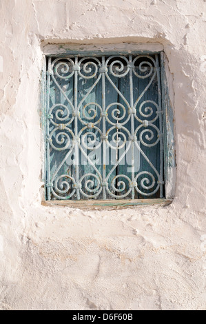 Old blue painted window shutters and wrought iron work Tamezret Tunisia Stock Photo