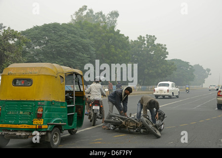 A tut-tut and motorcycle accident in New Delhi, India Stock Photo