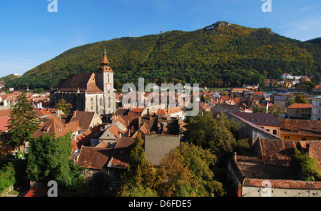 Brasov most important landmark, the Black Church, the largest Gothic in Eastern Europa, towers over the old town. Romania Stock Photo