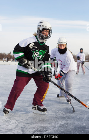 Players compete in a game at the U.S. Pond Hockey Championships on Lake Nokomis on January 20, 2013 in Minneapolis, Minnesota. Stock Photo