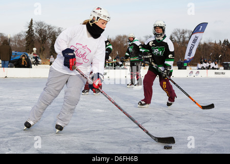 Players compete in a game at the U.S. Pond Hockey Championships on Lake Nokomis on January 20, 2013 in Minneapolis, Minnesota. Stock Photo