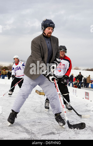 Players compete in a game at the U.S. Pond Hockey Championships on Lake Nokomis on January 19, 2013 in Minneapolis, Minnesota. Stock Photo