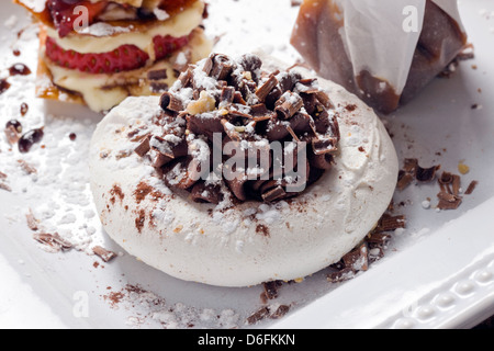 Gourmet desserts; Chocolate Extraordinaire: dark chocolate espresso ganache in hazelnut meringue shells sprinkled with chocolate Stock Photo
