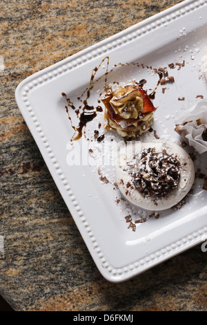 Chocolate Extraordinaire: dark chocolate espresso ganache in hazelnut meringue shells sprinkled with chocolate shavings Stock Photo