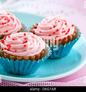 Closeup of delicious pink chocolate bonbons on shabby chic pastel color background Stock Photo