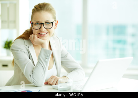 Portrait of successful businesswoman at workplace looking at camera Stock Photo