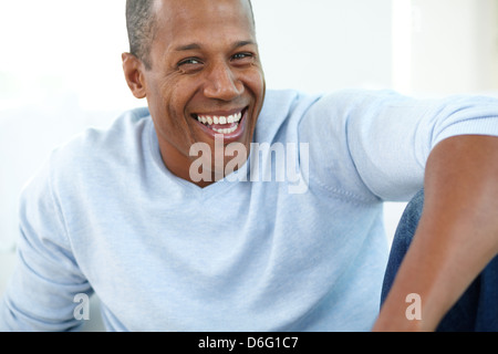 Image of young African man looking at camera and laughing Stock Photo