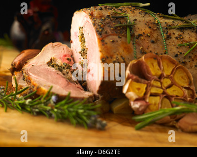 Sliced leg of stuffed lamb with garlic, rosemary and roast onion Stock Photo