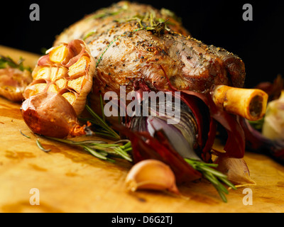 Sliced leg of stuffed lamb with garlic, rosemary and roast onion Stock Photo