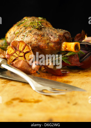 Sliced leg of stuffed lamb with garlic, rosemary and roast onion Stock Photo