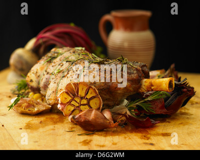 Sliced leg of stuffed lamb with garlic, rosemary and roast onion Stock Photo