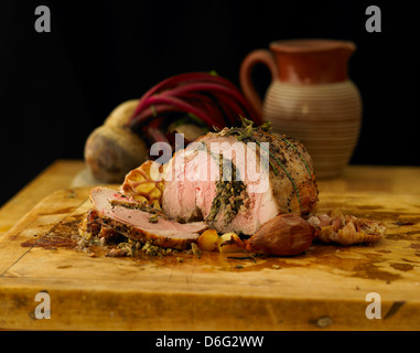 Sliced leg of stuffed lamb with garlic, rosemary and roast onion Stock Photo