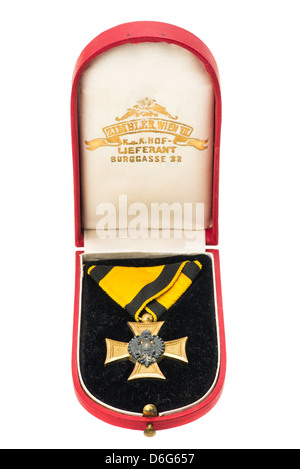 A boxed Nazi gold cross medal with ribbons from the Second World War - studio shot with a white background Stock Photo