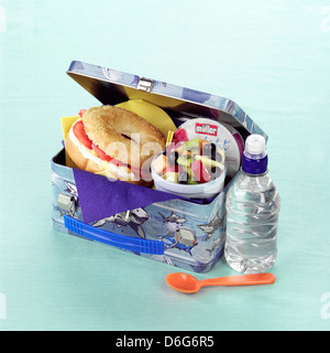 Children's lunch box with hard-boiled egg and tomato bagel and fruit salad Stock Photo