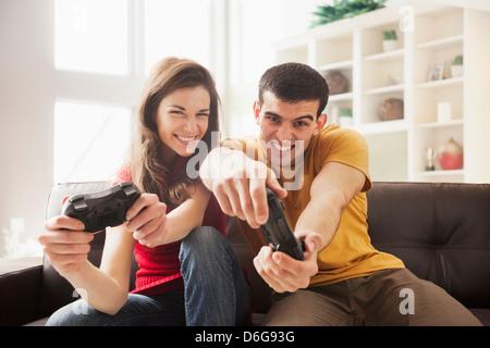 Couple playing video games together Stock Photo