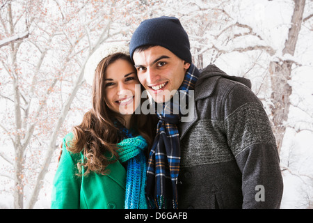 Smiling couple walking in show Stock Photo