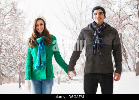 Smiling couple holding hands in show Stock Photo