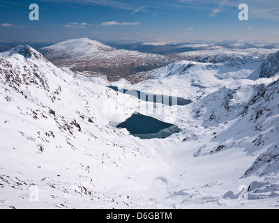 Snowdon in winter conditions - view down Cwm Dyli across Glaslyn & Llyn Llydaw to Moel Siabod Stock Photo